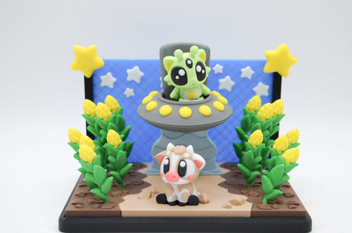 Colorful alien cow abduction diorama with UFO, cow, plants, and stars