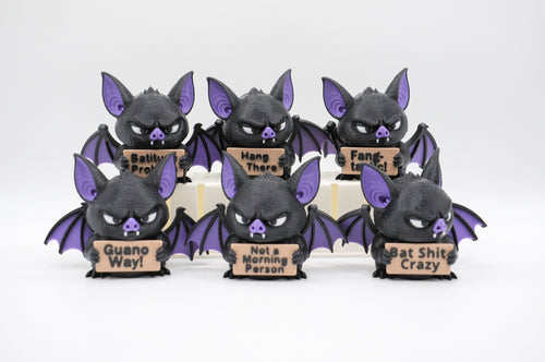 Group of bat figures holding six humorous signs