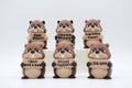 Group of beaver figures holding six humorous signs