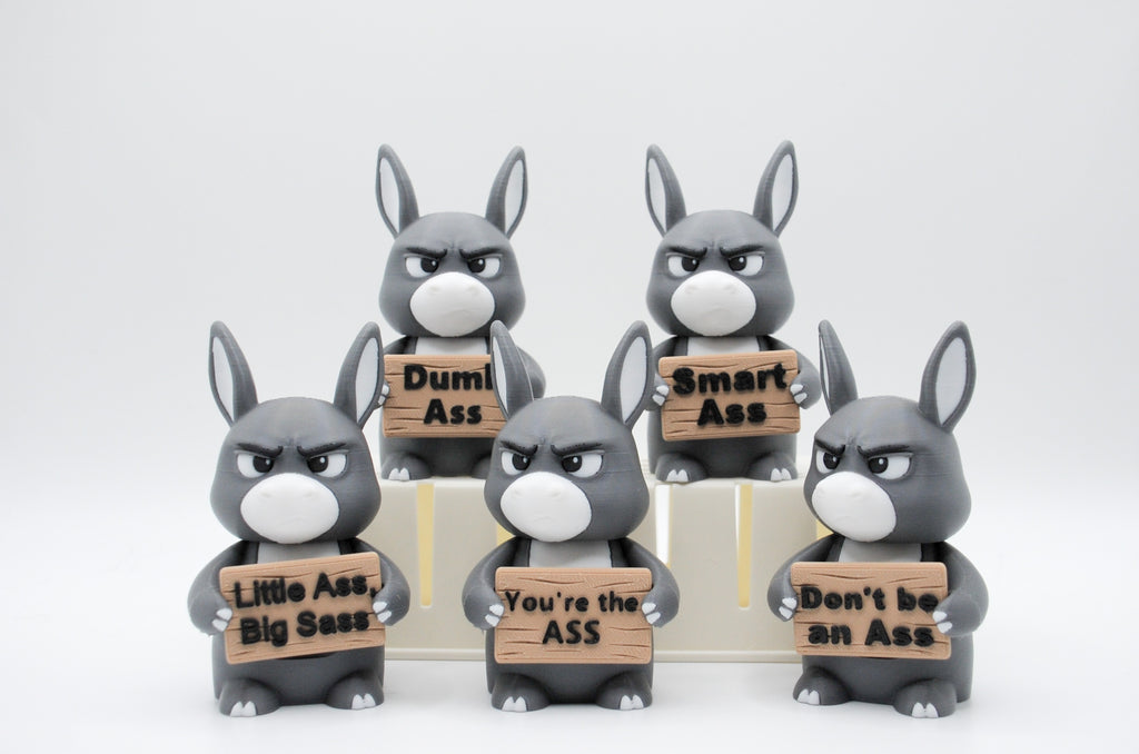 Group of donkey figures holding five humorous signs