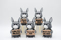 Group of donkey figures holding five humorous signs