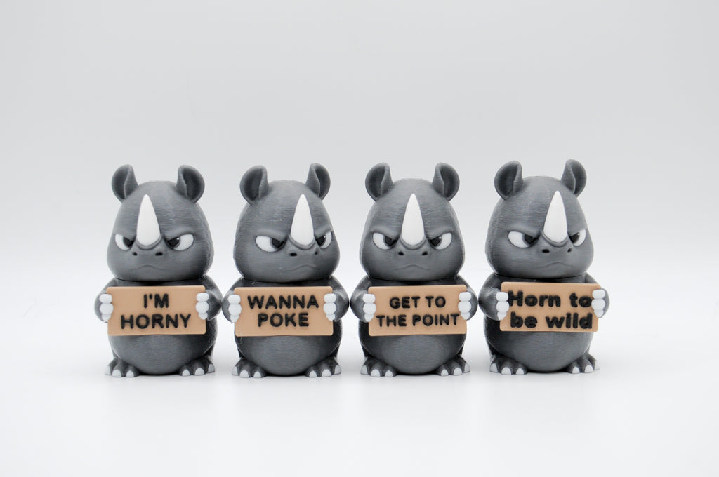 Group of rhinoceros figures holding four humorous signs