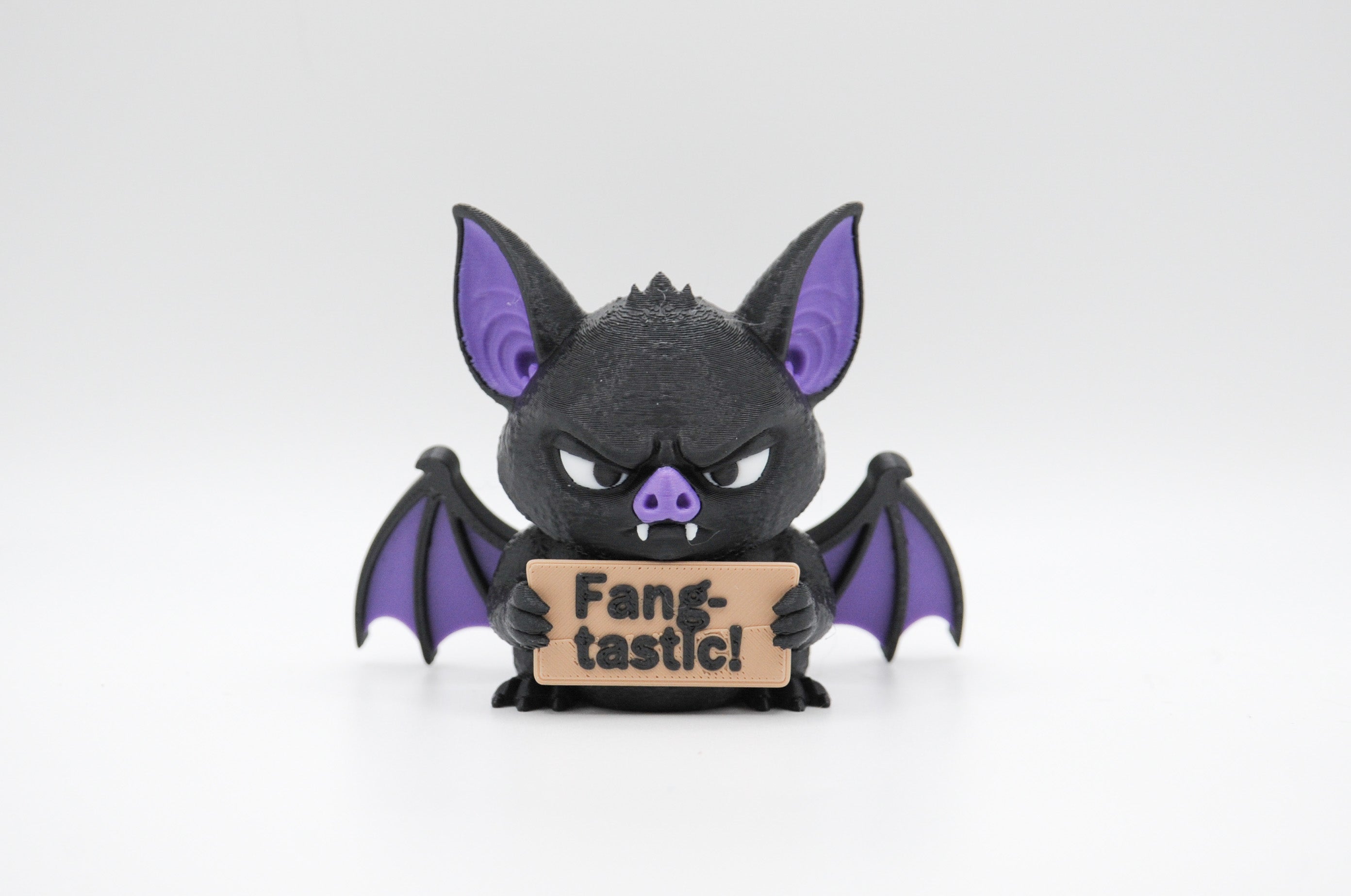 Bat holding a Fang-tastic sign