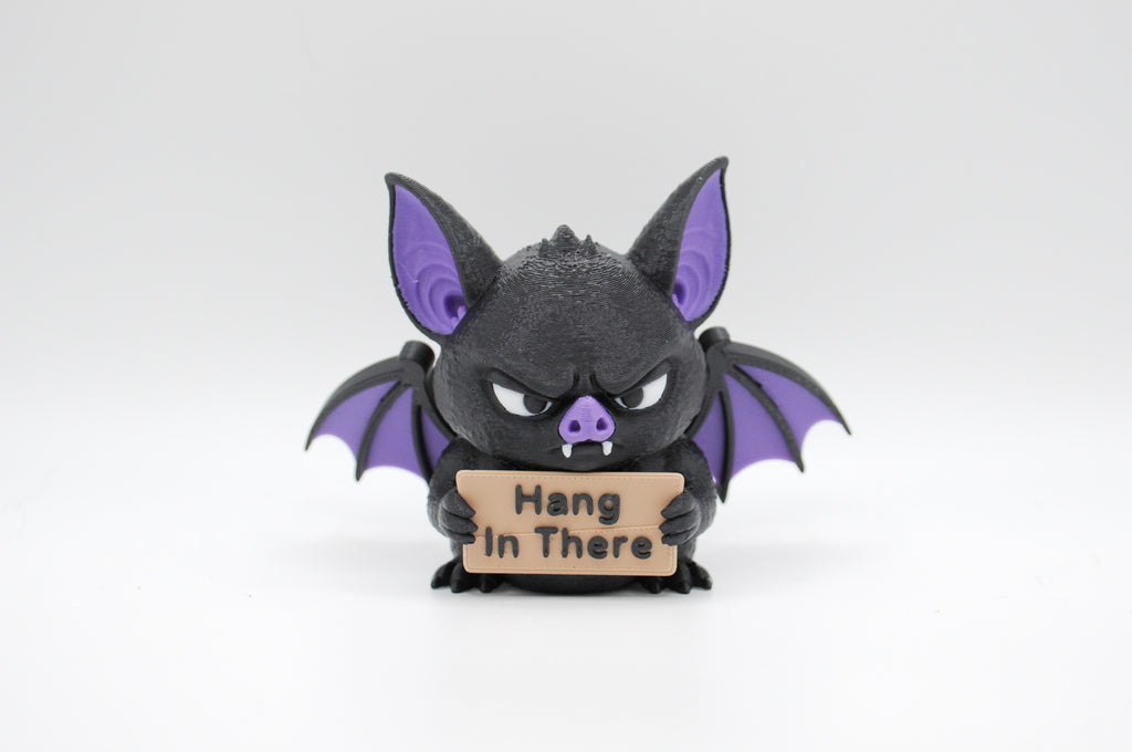Bat holding a Hang in There sign