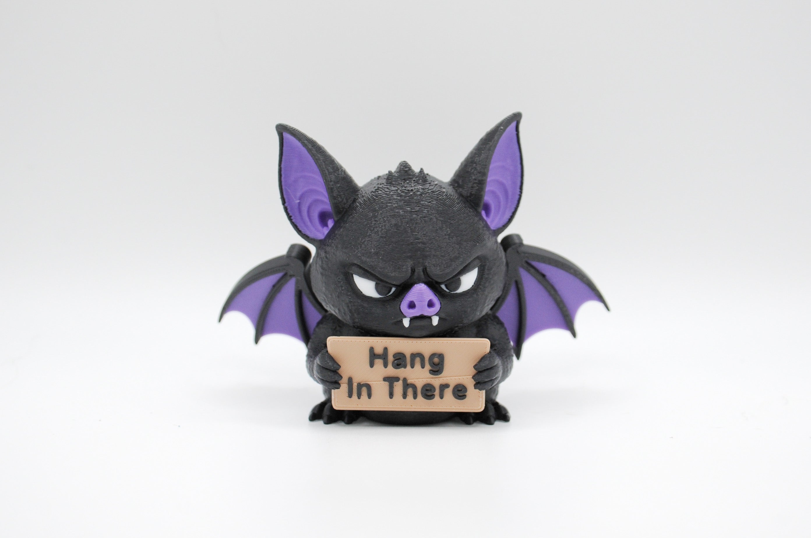 Bat holding a Hang in There sign