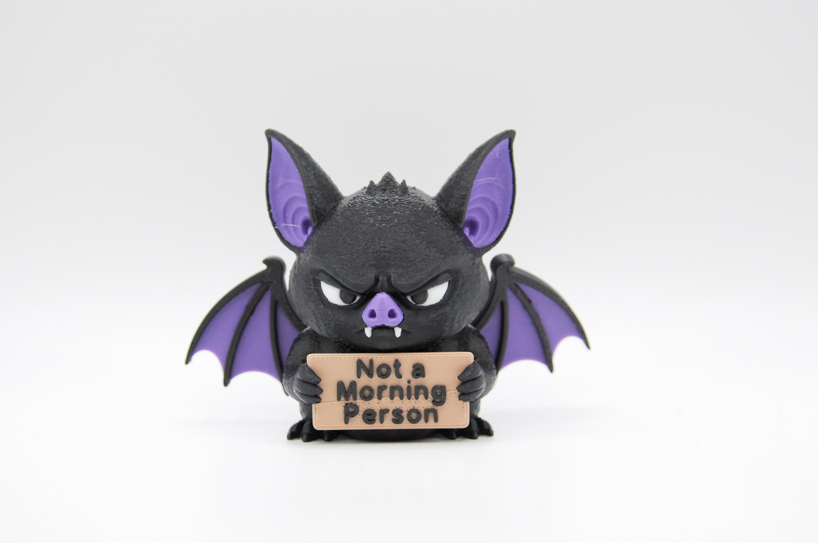 Bat holding a Not a Morning Person sign