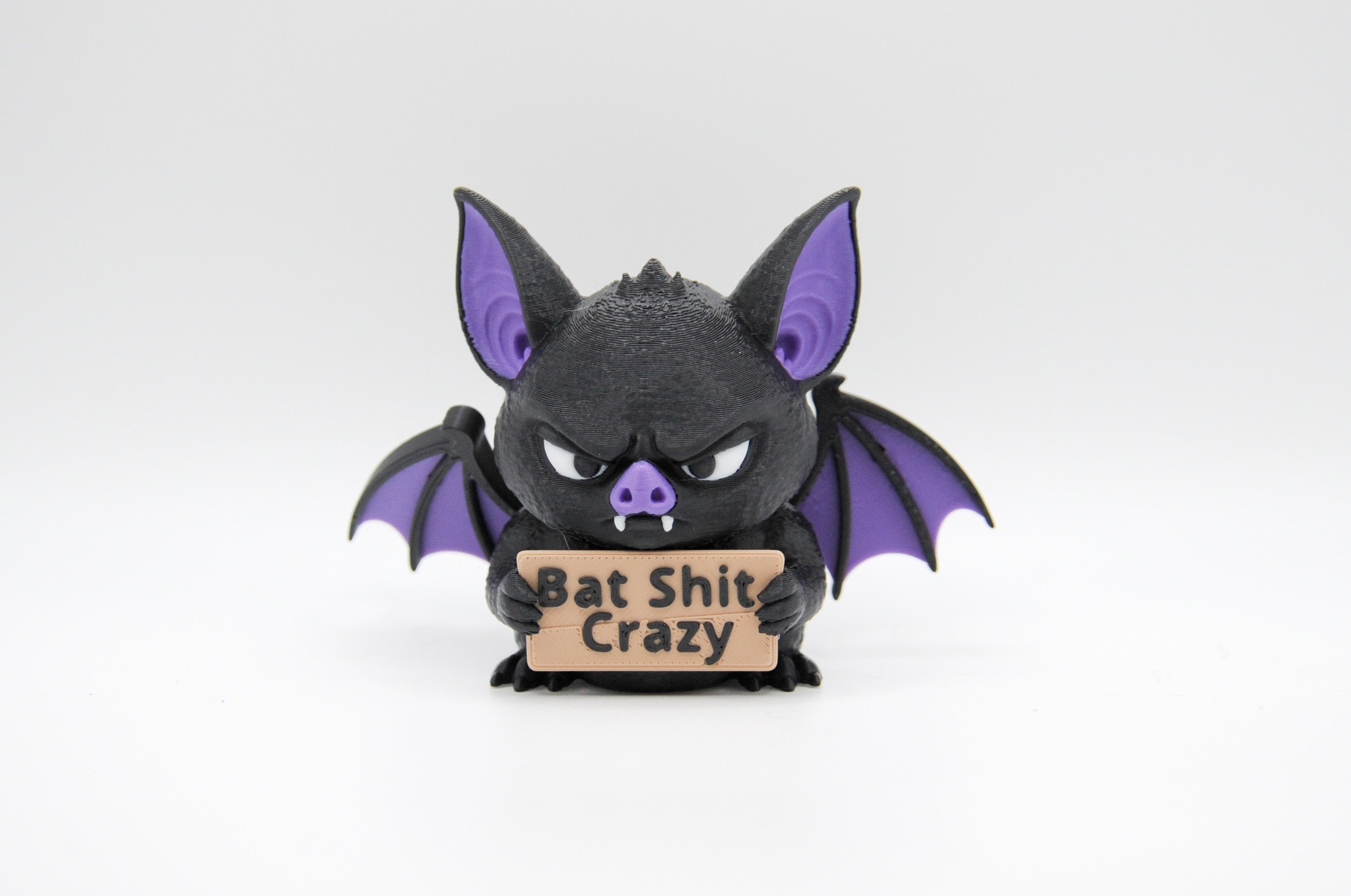 Bat holding a Bat Shit Crazy sign