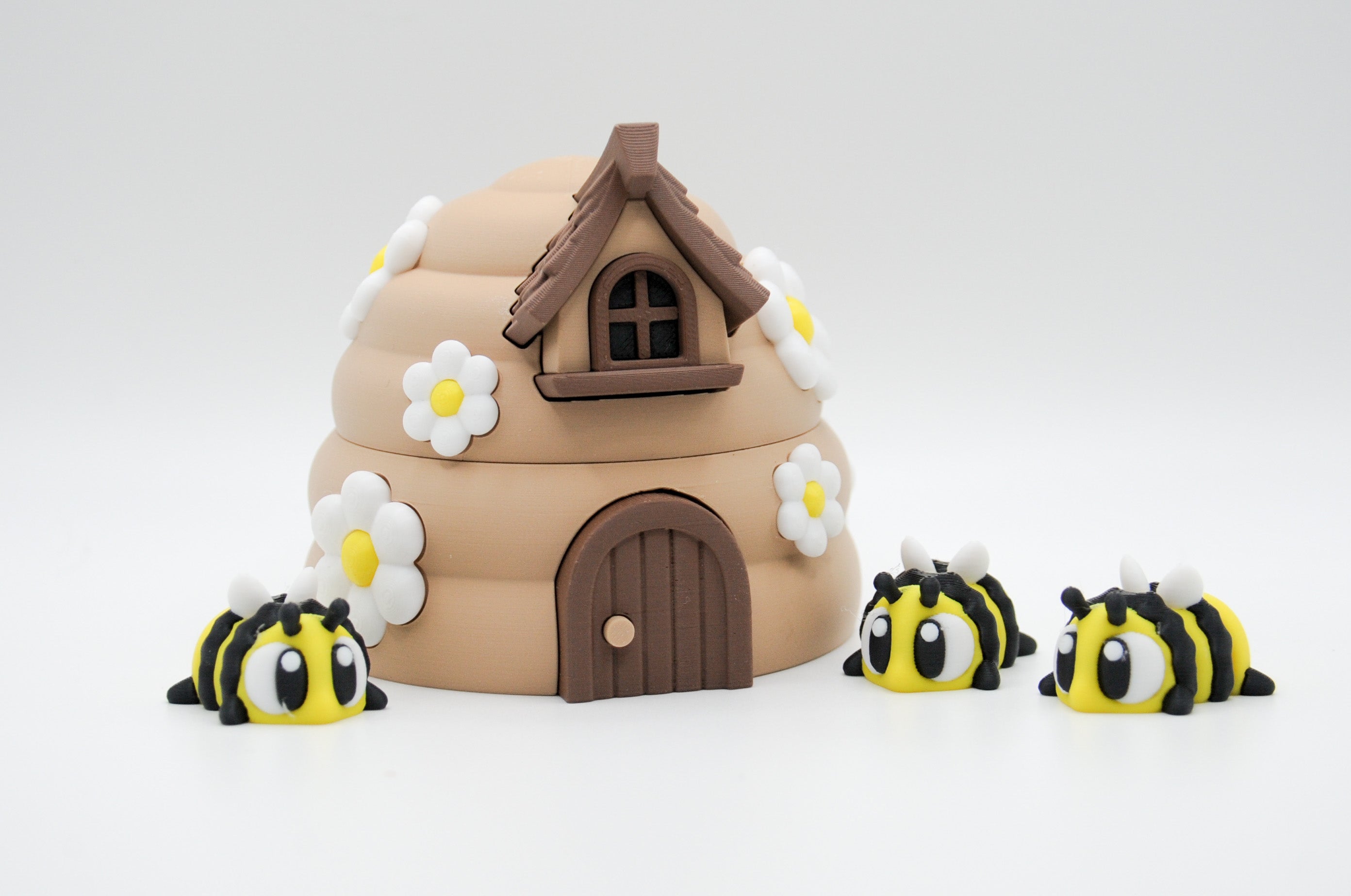 Alternate view of a flower-covered bee hive and striped bee figures