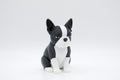 Black and white Boston terrier figure seated upright
