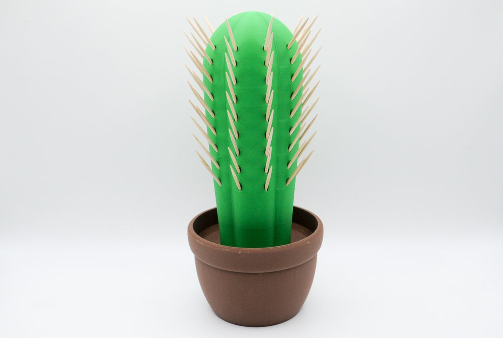 Green cactus toothpick holder in a brown pot