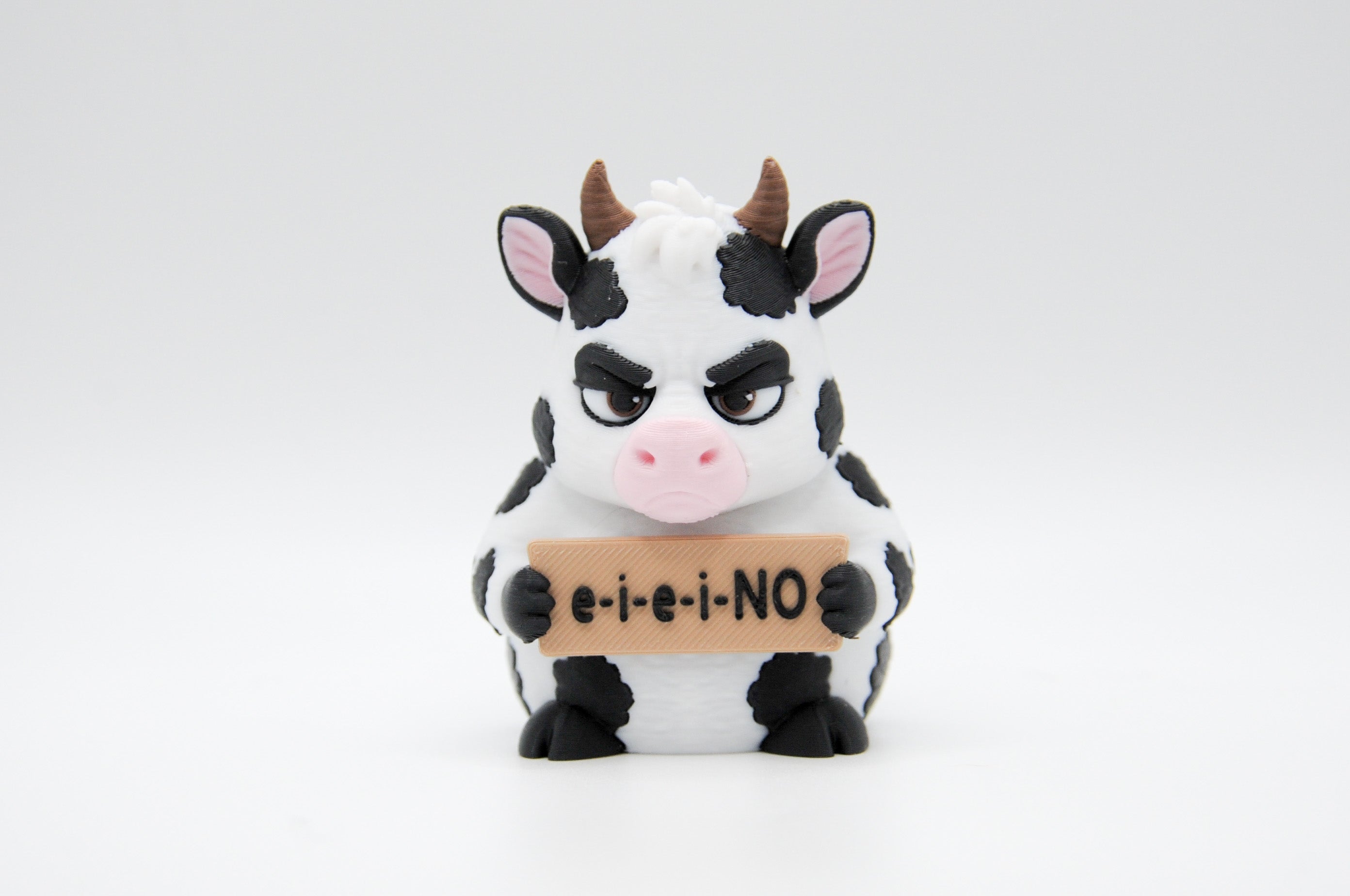 Cow holding an E-I-E-I-NO sign