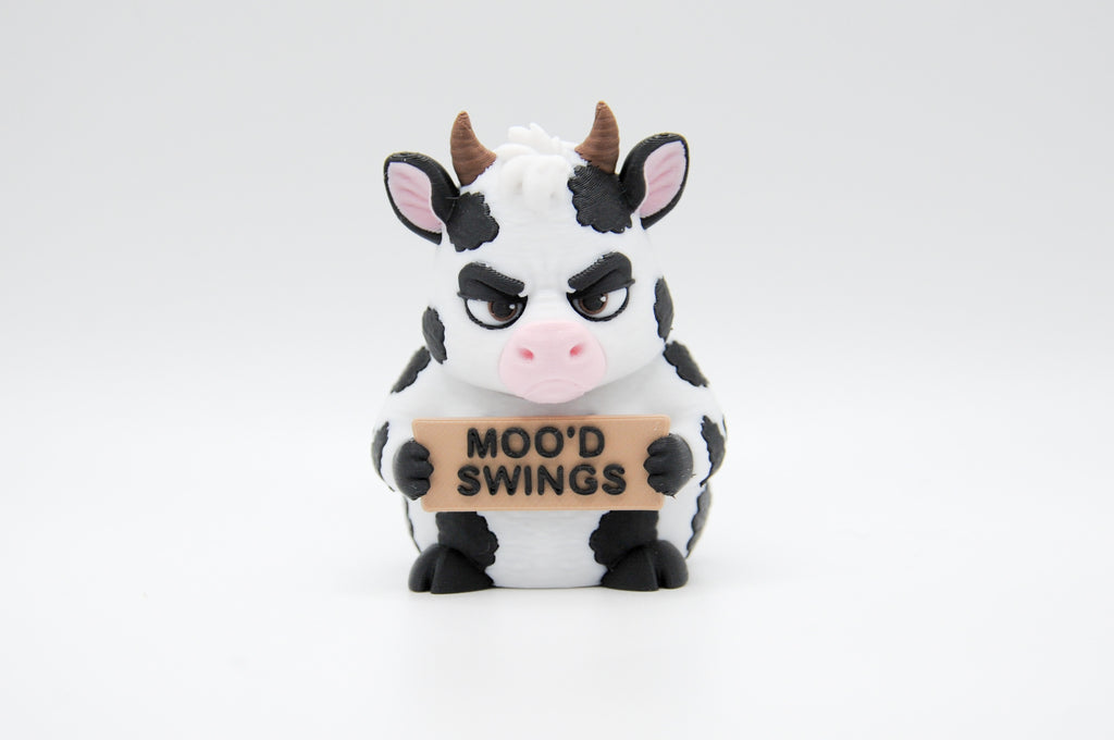 Cow holding a Moo'd Swings sign