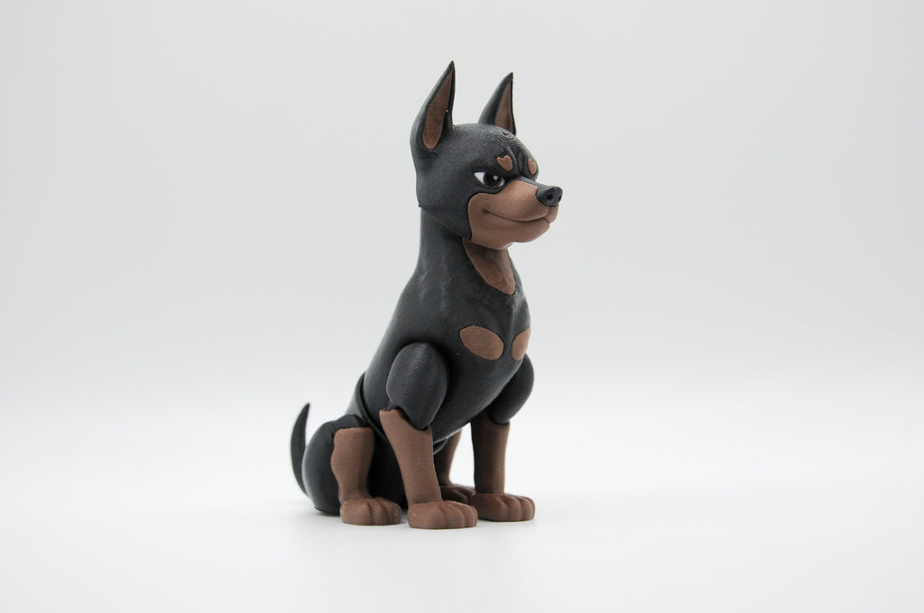 Black and tan Doberman figure seated in profile