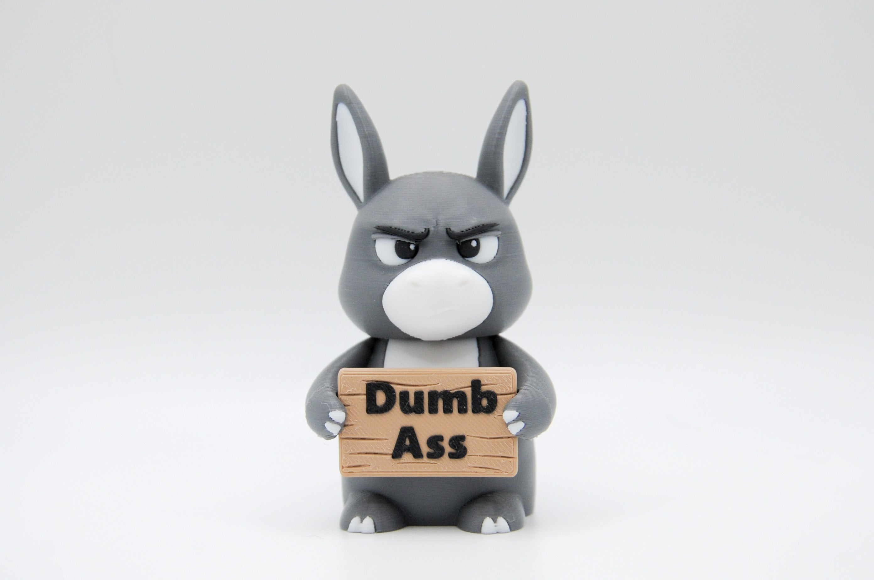 Donkey holding a Dumb Ass sign