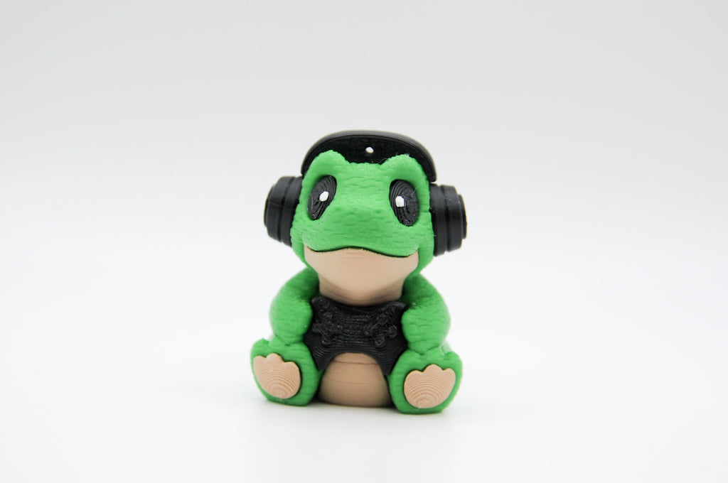 Seated green frog figure wearing large black headphones