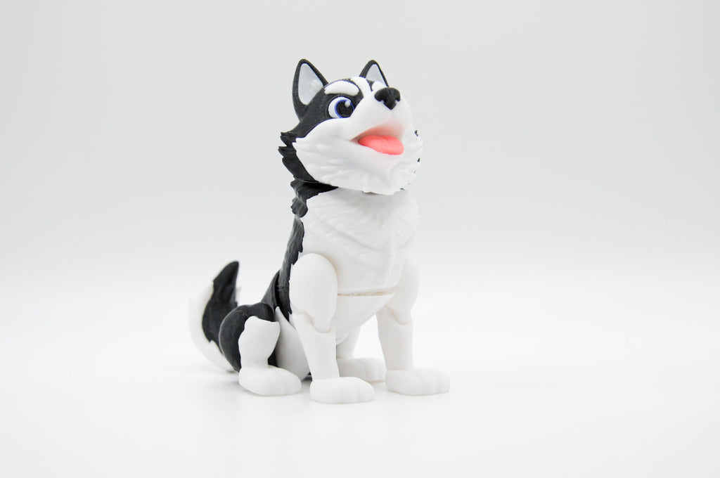 Black and white husky figure seated against a white background