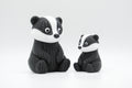 Black, white, and gray knitted-style badger figures in large and small sizes