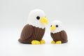 Brown and white knitted-style bald eagle figures in large and small sizes