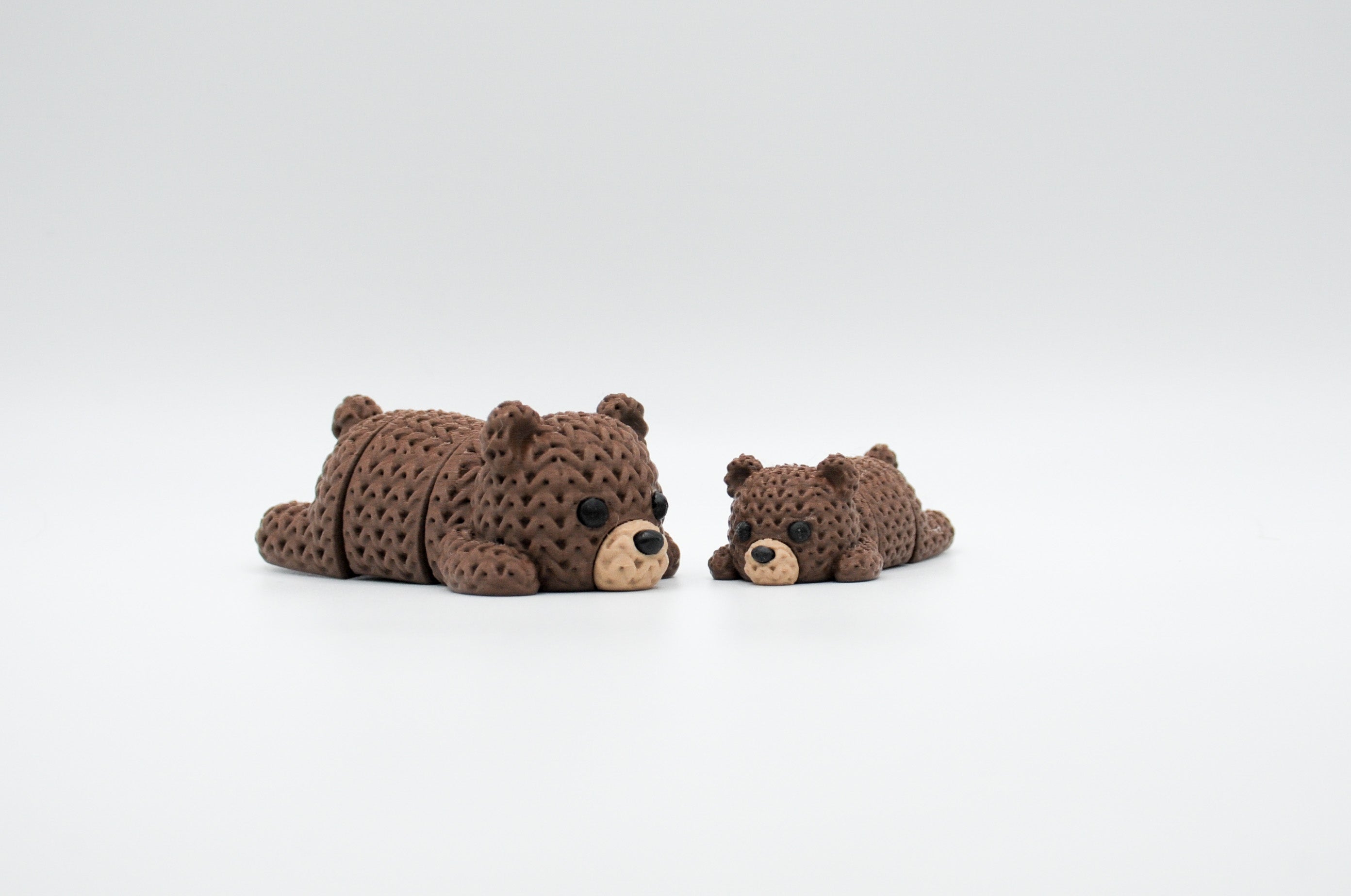 Brown knitted-style sleeping bear figures in large and small sizes