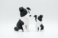 Black and white knitted-style border collie figures in large and small sizes