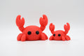Coral-red knitted-style crab figures in large and small sizes