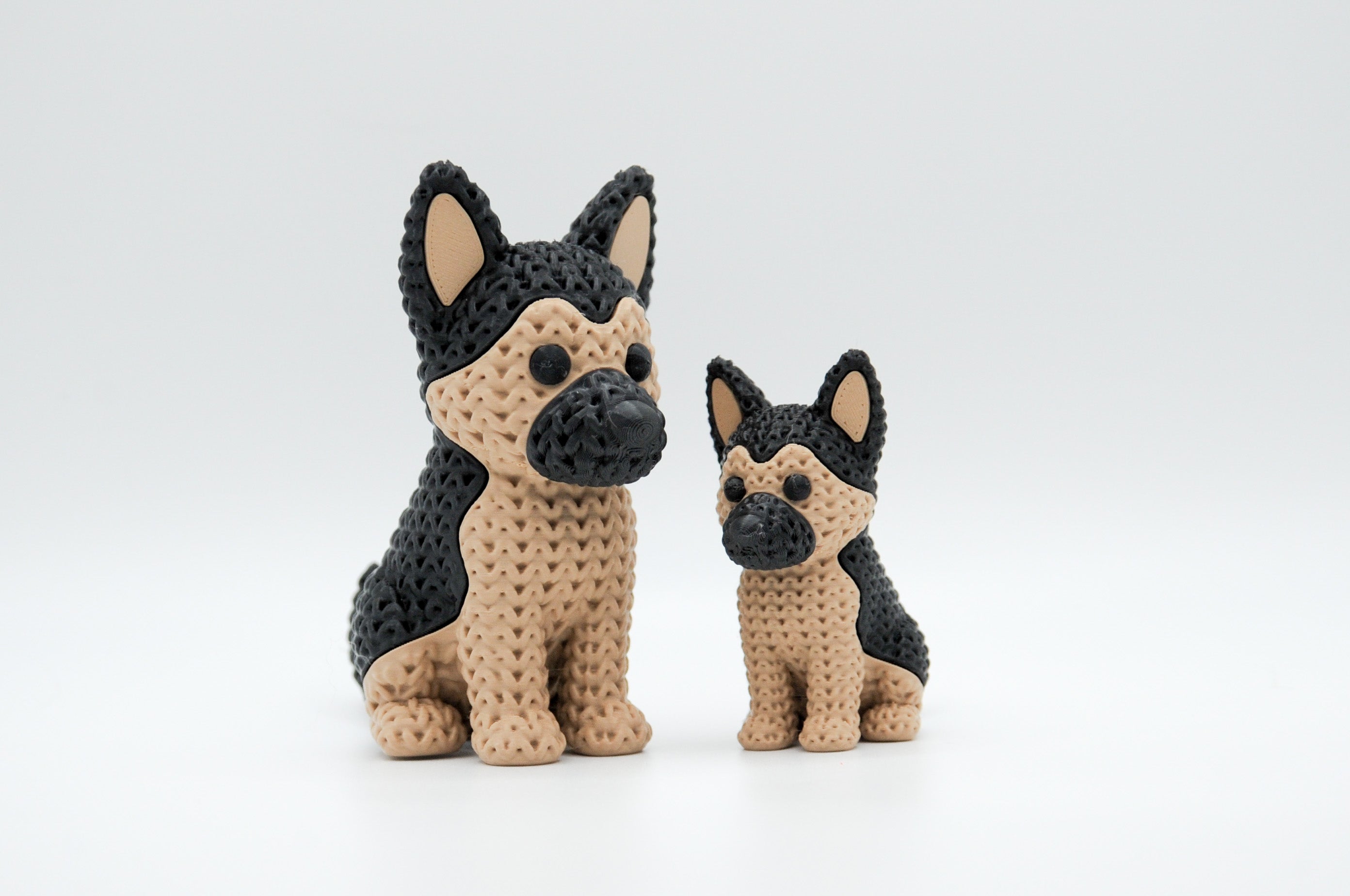 Tan and black knitted-style German shepherd figures in large and small sizes