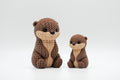Brown knitted-style otter figures in large and small sizes