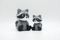 Gray knitted-style raccoon figures in large and small sizes