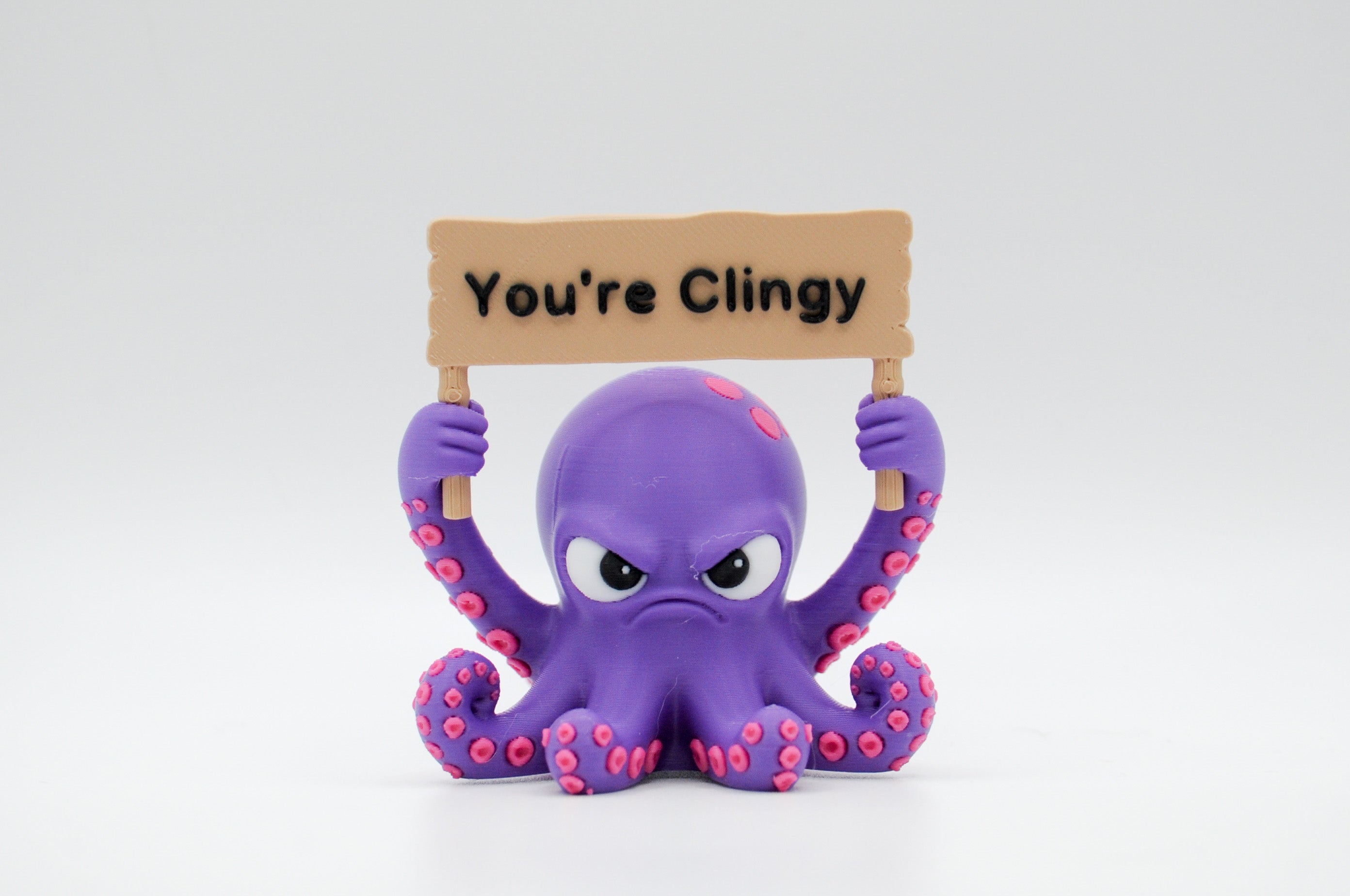 Purple octopus holding a You're Clingy sign