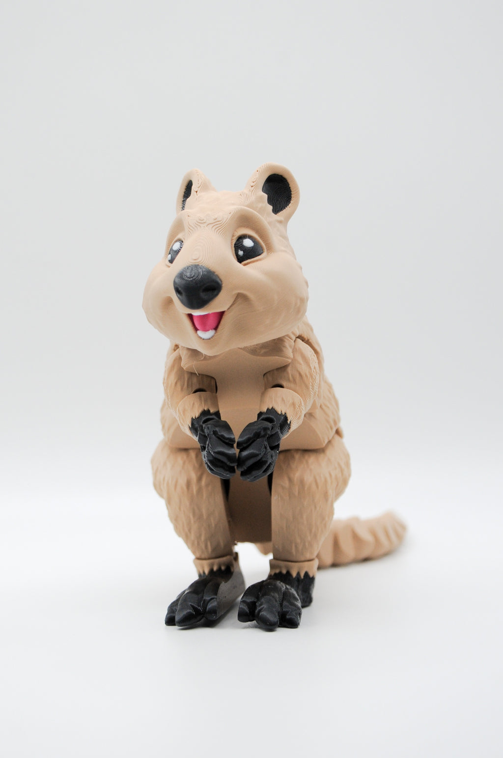 Portrait view of a smiling upright tan quokka figure
