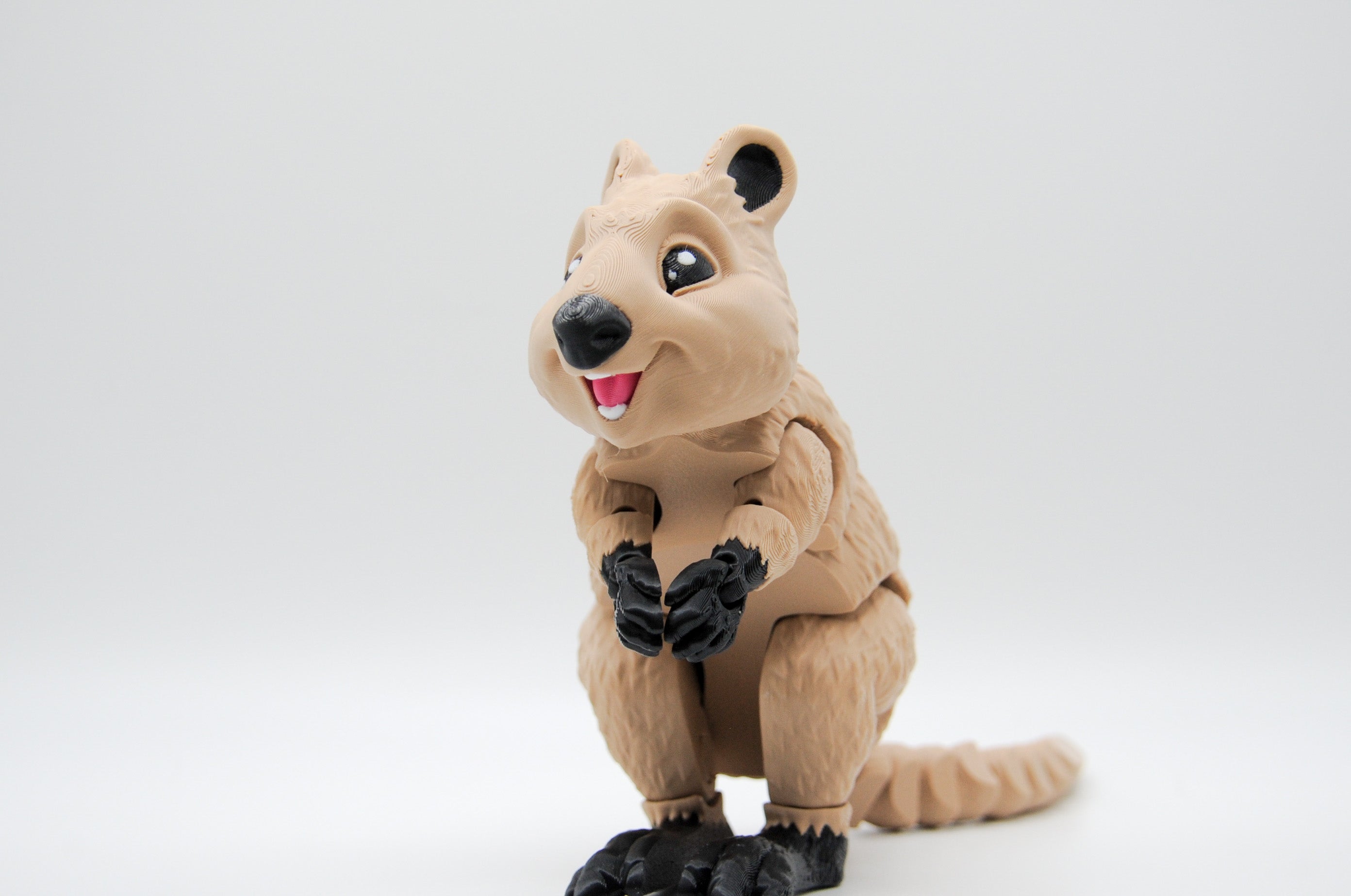 Smiling tan quokka figure standing upright
