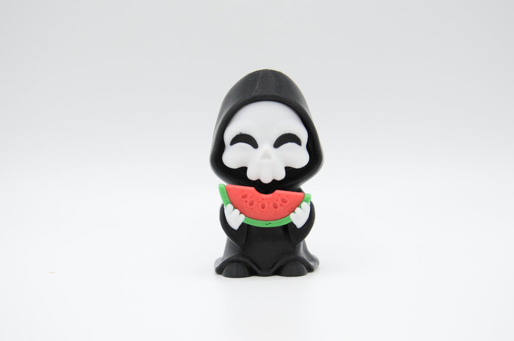 Hooded reaper figure eating a slice of watermelon