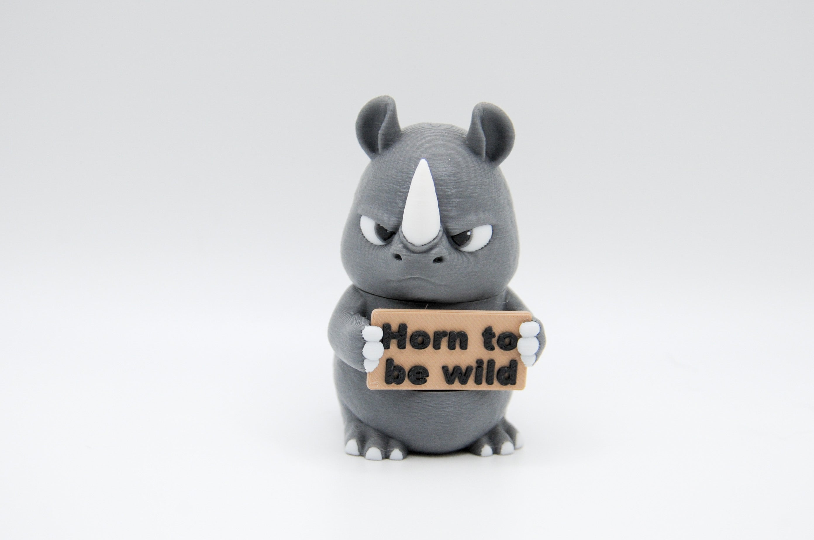 Rhinoceros holding a Horn to Be Wild sign