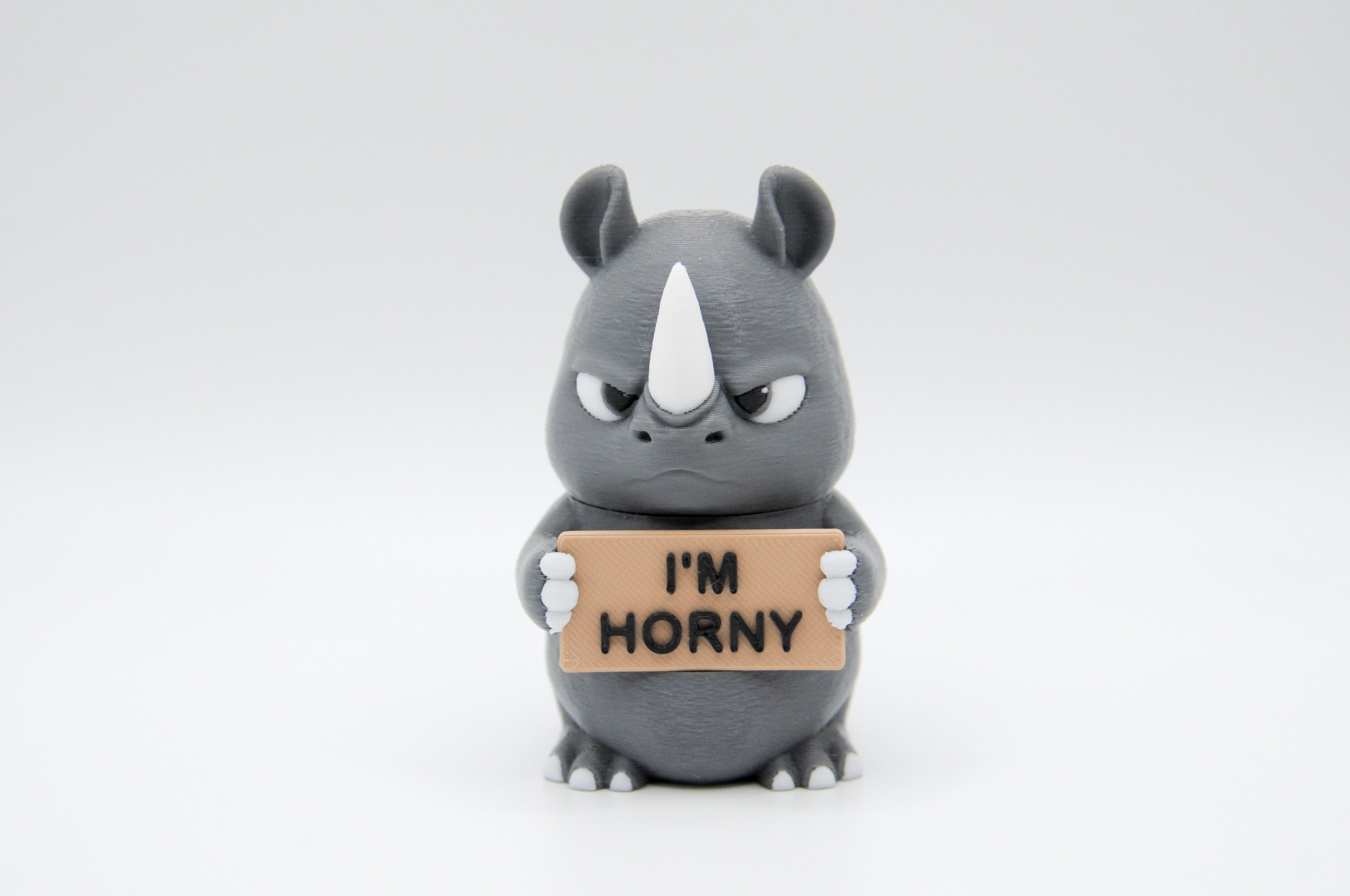 Rhinoceros holding an I'm Horny sign