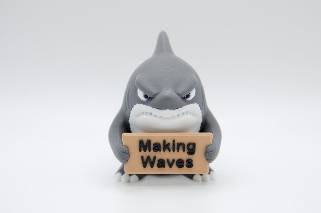 Shark holding a Making Waves sign