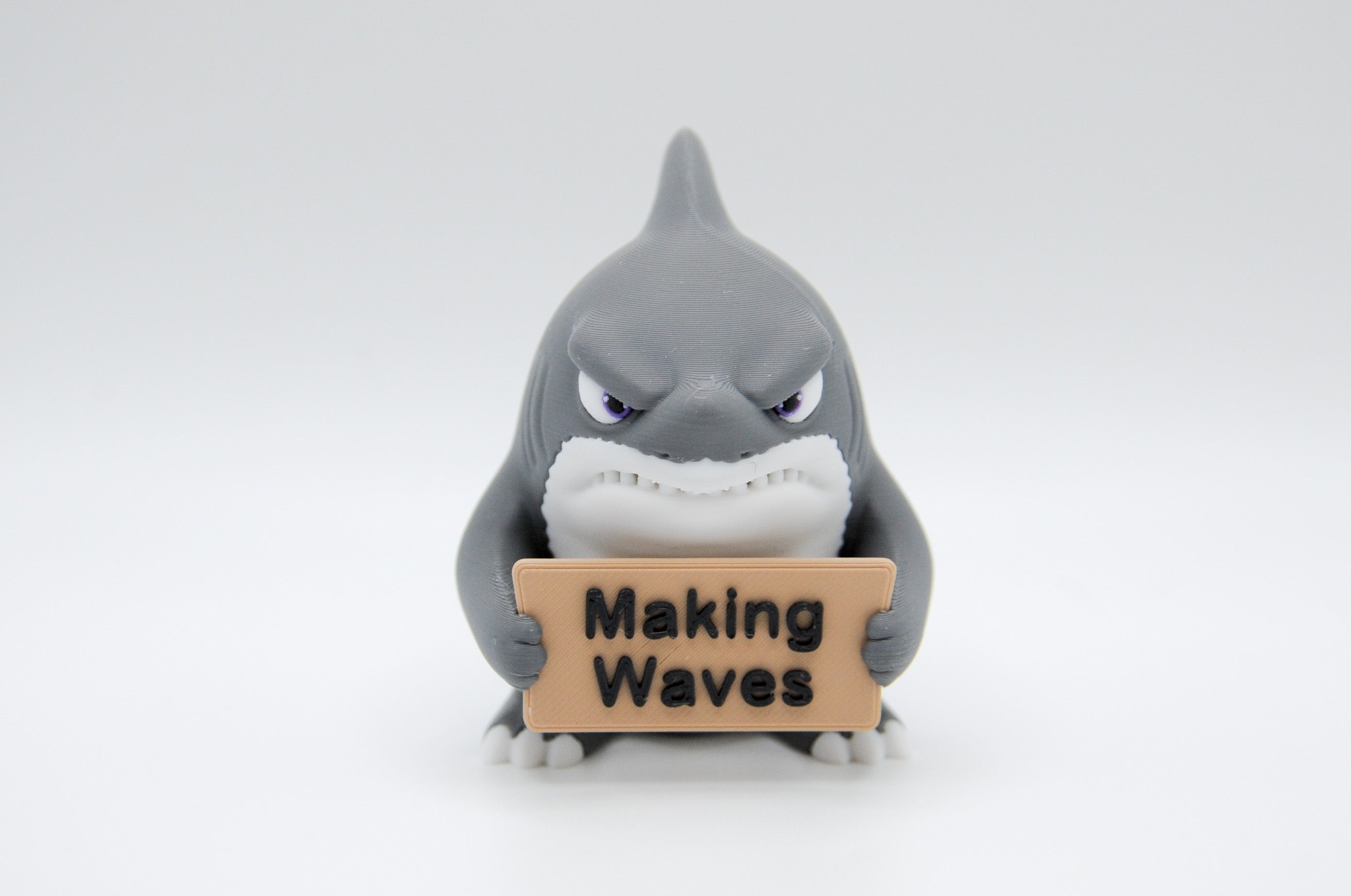 Shark holding a Making Waves sign