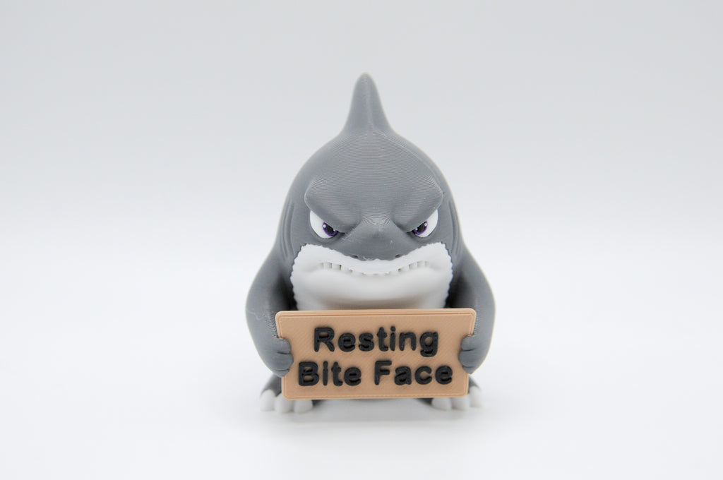 Shark holding a Resting Bite Face sign