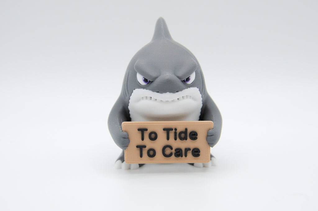 Shark holding a To Tide To Care sign