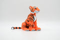 Orange tiger figure with bold black stripes and long tail