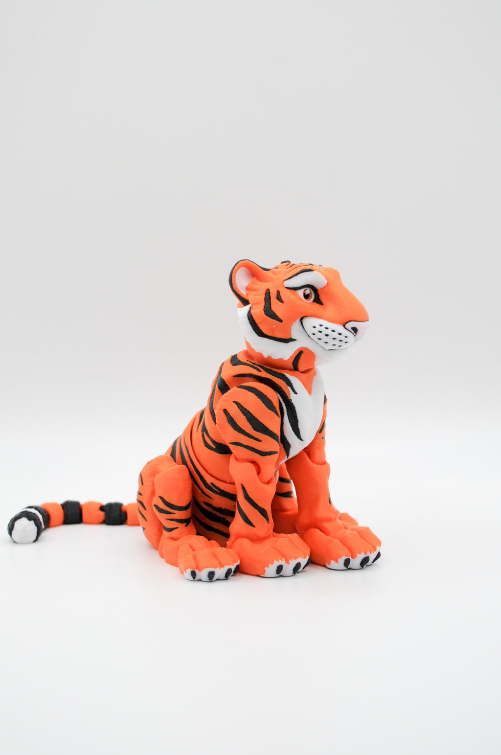 Portrait view of an orange tiger figure with black stripes