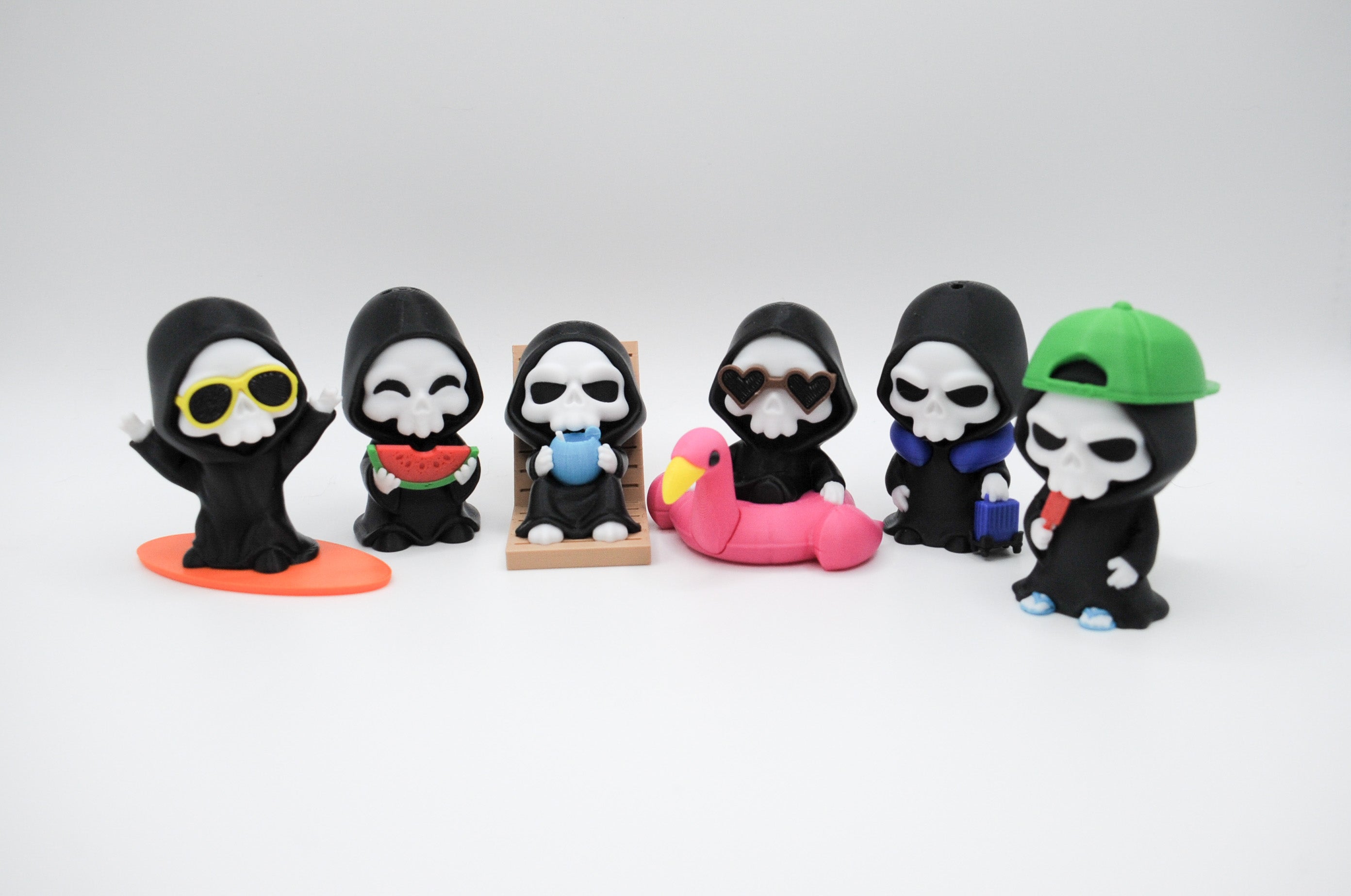 Group of six hooded reaper figures with vacation accessories